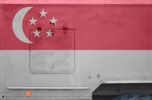 Singapore flag depicted on side part of military armored truck closeup. Army forces conceptual background photo