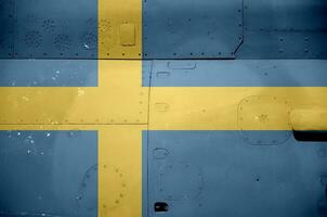 Sweden flag depicted on side part of military armored helicopter closeup. Army forces aircraft conceptual background photo