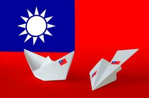 Taiwan flag depicted on paper origami airplane and boat. Handmade arts concept photo