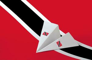 Trinidad and Tobago flag depicted on paper origami airplane. Handmade arts concept photo