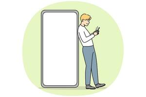 Young man standing near huge smartphone with mockup screen. Guy pose near cellphone with empty blank copy space display. Vector illustration.