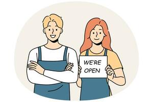 Smiling waiters in aprons hold open sign. Happy man and woman cafe staff notify about shop opening. Vector illustration.