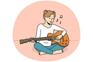 niña sonriente sentada en el suelo tocando la guitarra. la mujer feliz disfruta de una lección musical con un instrumento. pasatiempo y entretenimiento. ilustración vectorial vector