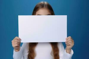 AI generated Cute little girl holding blank white sheet of paper in her hands photo