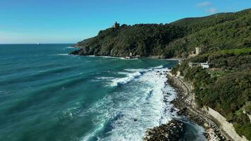 Aerial view of a bay with white waves crashing on the rocks video