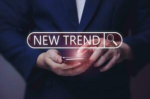 New Trends concept. Men use a smartphone to search online. trends of change, media assets, hot topics, and relevant new trends in business. and online media creation content photo