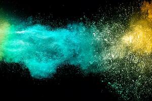 Abstract multicolored powder explosion on black background. Red and blue dust particles splattered on background. photo