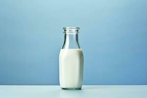 AI generated A glass bottle with full milk on blue background. AI Generated photo