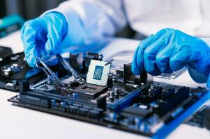 The technician repairing the motherboard in the lab with copy space. the concept of computer hardware, mobile phone, electronic, repairing, upgrade photo