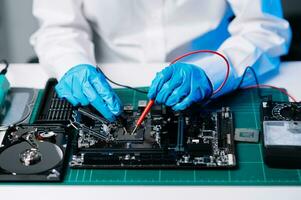 The technician is putting the CPU on the socket of the computer motherboard. electronic engineering electronic repair, electronics measuring and testing, repair photo