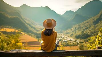 AI generated Back view of hipster girl sitting, with background of beautiful mountains scene photo