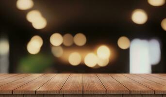 Empty wooden table top with lights bokeh on blur restaurant background. photo