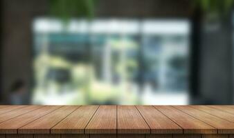 Empty wooden table top with lights bokeh on blur restaurant background. photo