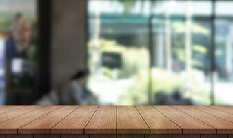 Empty wooden table top with lights bokeh on blur restaurant background. photo