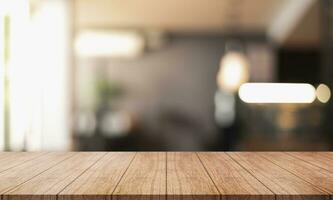 Empty wooden table top with lights bokeh on blur restaurant background. photo