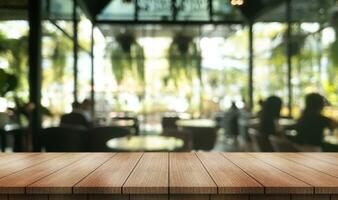 Empty wooden table top with lights bokeh on blur restaurant background. photo