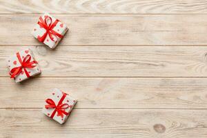 Valentine day composition red  gift box with bow and heart. Christmas present. View from above. Space for text. Holday greeting card photo