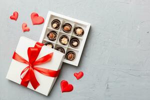 Valentine day composition red  for Valentine's Day. Heart shaped box of chocolates top view with copy space photo