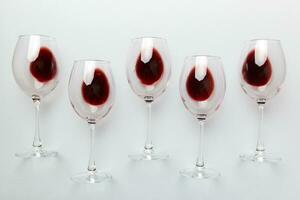 Many glasses of red wine at wine tasting. Concept of red wine on colored background. Top view, flat lay design photo