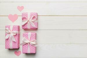 Valentine day composition red gift box with bow and heart. Christmas present. View from above. Space for text. Holday greeting card photo