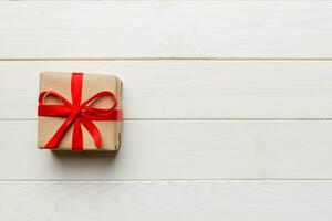 Valentine day composition red  gift box with bow and heart. Christmas present. View from above. Space for text. Holday greeting card photo