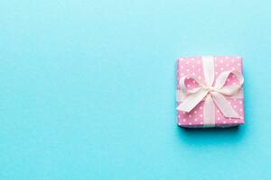 Valentine day composition red  gift box with bow and heart. Christmas present. View from above. Space for text. Holday greeting card photo