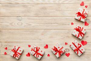 Valentine day composition red gift box with bow and heart. Christmas present. View from above. Space for text. Holday greeting card photo