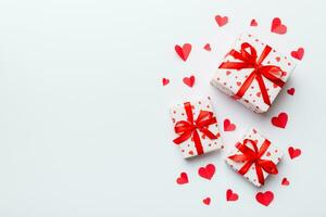 Valentine day composition red gift box with bow and heart. Christmas present. View from above. Space for text. Holday greeting card photo