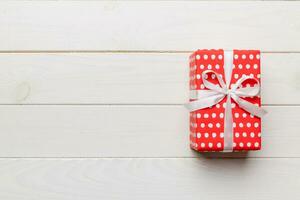 Valentine day composition red  gift box with bow and heart. Christmas present. View from above. Space for text. Holday greeting card photo