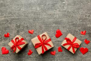 Valentine day composition red  gift box with bow and heart. Christmas present. View from above. Space for text. Holday greeting card photo