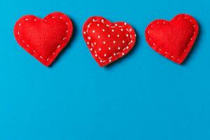 Top view of textile hearts on colorful background. Valentine's day concept with copy space photo