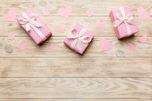 Valentine day composition red  gift box with bow and heart. Christmas present. View from above. Space for text. Holday greeting card photo