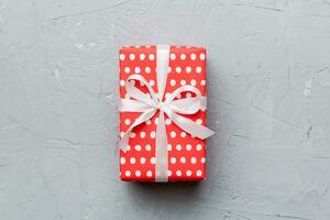 Valentine day composition red  gift box with bow and heart. Christmas present. View from above. Space for text. Holday greeting card photo