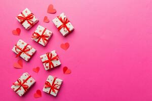 Valentine day composition red  gift box with bow and heart. Christmas present. View from above. Space for text. Holday greeting card photo