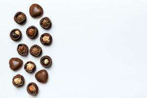 Different kinds of chocolates on colored table close-up. Top View and Flat Lay with copy space photo