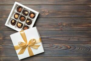 White box with chocolates candies and golden tape. top view with copy space photo