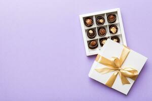 White box with chocolates candies and golden tape. top view with copy space photo