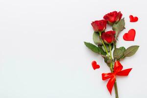 Valentine day composition with rose flower and red heart on table. Top view, flat lay, copy space Holiday concept photo