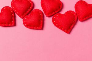 Composition of textile red hearts on colorful background with empty space for your design. Top view of St. Valentine's day concept photo