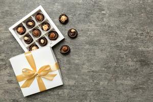 White box with chocolates candies and golden tape. top view with copy space photo