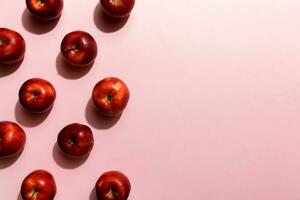 Many red apples on colored background, top view. Autumn pattern with fresh apple above view photo
