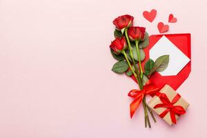 Valentine day composition with Envelope, rose flower and Red heart on table. Top view, flat lay. Holiday concept photo