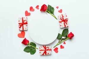 Frame made of rose, git box, heart and blank greeting card mockup on Colored background. Top view, flat lay, copy space Holiday, Mothers Day, birthday concept photo