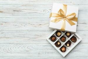 White box with chocolates candies and golden tape. top view with copy space photo