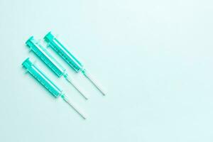 Top view of medical syringes on colorful background with copy space. Injection equipment concept photo