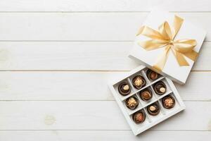 White box with chocolates candies and golden tape. top view with copy space photo