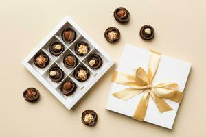 White box with chocolates candies and golden tape. top view with copy space photo