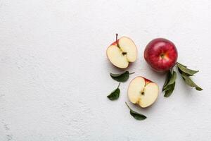 Fresh red apples with green leaves on wooden table. On wooden background. Top view free space for text photo