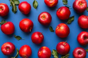 Many red apples on colored background, top view. Autumn pattern with fresh apple above view photo