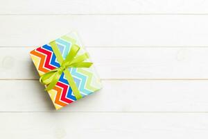 Top view of christmas or other holiday handmade present box package, flat lay white wooden background with copy space. new year gift box photo